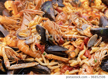 Italian Cavatelli allo scoglio, pasta with seafood and tomatoes close up in a frying pan 96852506