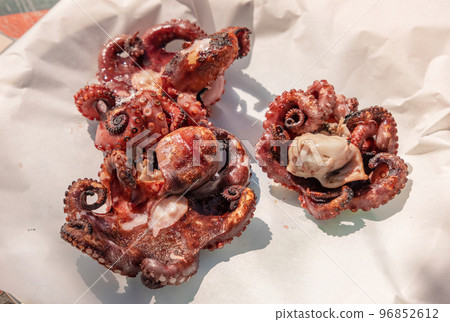 Freshly grilled octopused on a plate outdoor, Italy. Traditional Mediterranean cuisine. Freshly grilled octopused on a plate outdoor, Italy. Traditional Mediterranean cuisine. 96852612