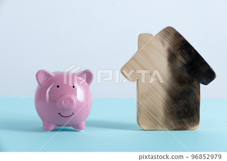 burn house and Piggy bank. Fire insurance concept burn house and Piggy bank. Fire insurance concept 96852979