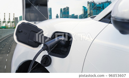 Eco friendly progressive clean energy concept with EV car with cityscape scenery 96853607