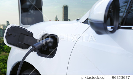 Progressive green city ESG symbol background with electric vehicle. Progressive green city ESG symbol background with electric vehicle. 96853677