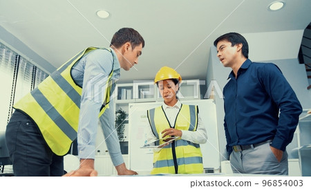 Engineers and competent employer discussing together with tablet in the office. Engineers and competent employer discussing together with tablet in the office. 96854003