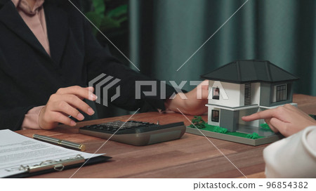 Closeup enthusiastic customer review contract paperwork for house loan. Closeup enthusiastic customer review contract paperwork for house loan. 96854382