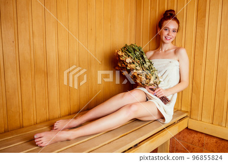 redhaired ginger woman steaming in the bathhouse with russian bunch birch broom .she enjoying heat sauna finnish spa,losing weight concept. Face pores opening redhaired ginger woman steaming in the bathhouse with russian bunch birch broom .she enjoying heat sauna finnish spa,losing weight concept. Face pores opening 96855824