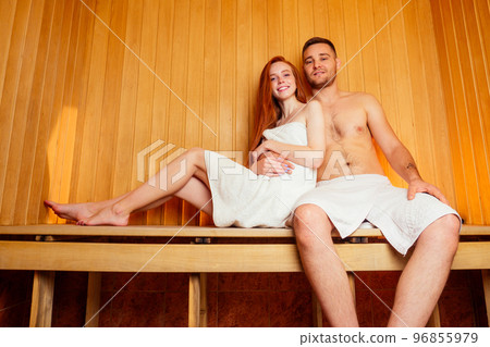 redhaired ginger woman and her boyfriend steaming in the bathhouse with russian bunch broom.couple in love enjoying the sauna together at the spa 96855979
