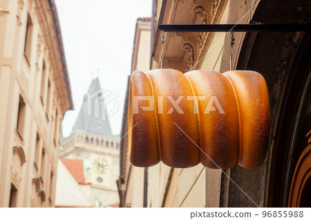 woman with an appetite eats a traditional Czech sweet Trdelnik in Prague street woman with an appetite eats a traditional Czech sweet Trdelnik in Prague street 96855988