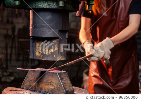 redhead ginger woman blacksmith portrait in workshop 96856000