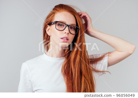 redhaired ginger woman wear glasses in white studio 96856049