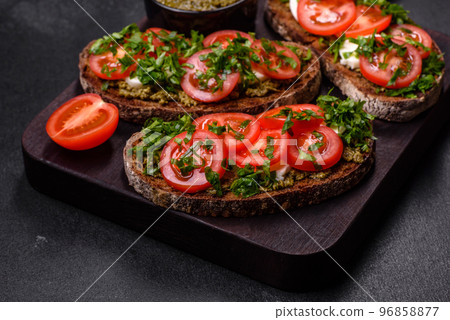 Tasty bruschetta with tomatoes, mozzarella, basil, spices and herbs Tasty bruschetta with tomatoes, mozzarella, basil, spices and herbs 96858877
