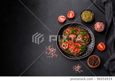 Tasty bruschetta with tomatoes, mozzarella, basil, spices and herbs 96858914