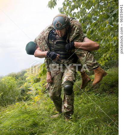 The commander carries a wounded soldier The commander carries a wounded soldier 96859441