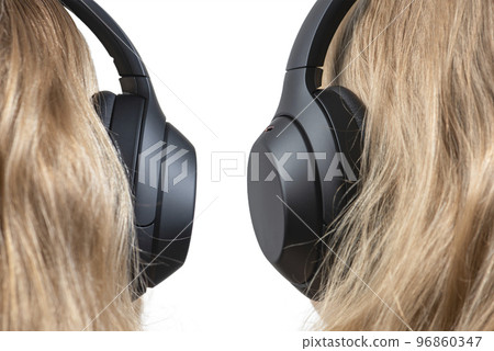 Woman in headphones isolated on white. Black headphones on a woman's head. Head of a fair-haired woman in headphones, rear view close-up. 96860347