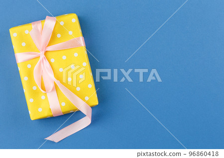 Present in gift paper on the table. 96860418