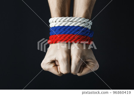hands tied with red blue white rope 96860419