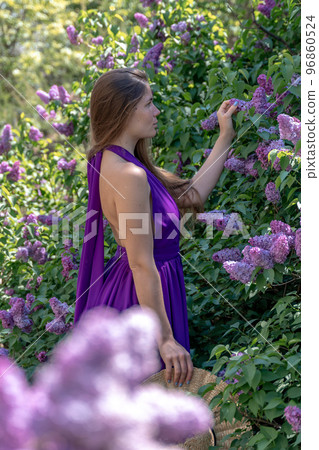 portrait of young woman with long hair outdoors in blooming lilac garden portrait of young woman with long hair outdoors in blooming lilac garden 96860524