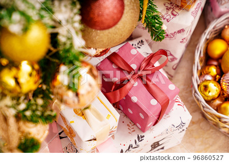 boxes with gifts on the Christmas tree with classic decorations. boxes with gifts on the Christmas tree with classic decorations. 96860527