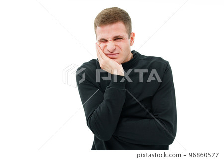 a man in a black robe holds on to his cheek on a white background. teeth hurt. a man in a black robe holds on to his cheek on a white background. teeth hurt. 96860577