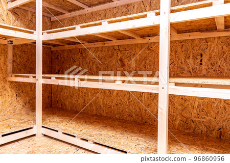 OSB racks, shelves are designed for storing things. Dressing room in the house. Organization of spaces in the house. Shelves in the garage. OSB racks, shelves are designed for storing things. Dressing room in the house. Organization of spaces in the house. Shelves in the garage. 96860956
