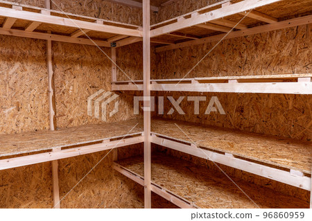 OSB racks, shelves are designed for storing things. Dressing room in the house. Organization of spaces in the house. Shelves in the garage. OSB racks, shelves are designed for storing things. Dressing room in the house. Organization of spaces in the house. Shelves in the garage. 96860959