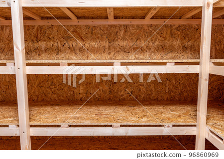 OSB racks, shelves are designed for storing things. Dressing room in the house. Organization of spaces in the house. Shelves in the garage. OSB racks, shelves are designed for storing things. Dressing room in the house. Organization of spaces in the house. Shelves in the garage. 96860969