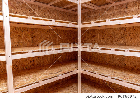 OSB racks, shelves are designed for storing things. Dressing room in the house. Organization of spaces in the house. Shelves in the garage. OSB racks, shelves are designed for storing things. Dressing room in the house. Organization of spaces in the house. Shelves in the garage. 96860972