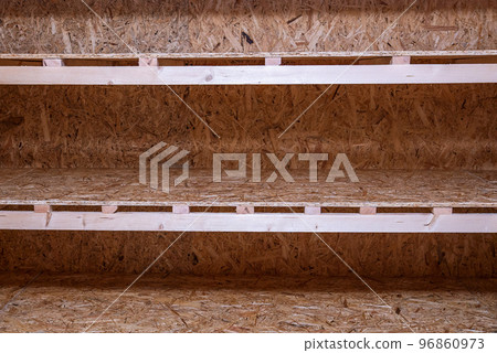 OSB racks, shelves are designed for storing things. Dressing room in the house. Organization of spaces in the house. Shelves in the garage. OSB racks, shelves are designed for storing things. Dressing room in the house. Organization of spaces in the house. Shelves in the garage. 96860973