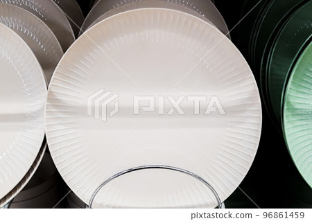 Sale of tableware in store. Ceramic plates on shelf in supermarket. Eco tableware in trendy neutral colors. Sale of tableware in store. Ceramic plates on shelf in supermarket. Eco tableware in trendy neutral colors. 96861459
