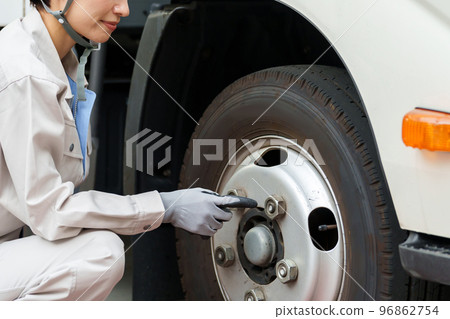 Mechanic inspecting tires Mechanic inspecting tires 96862754