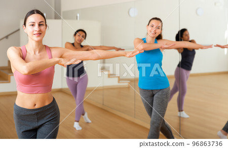 Group of smiling women training sport dance 96863736