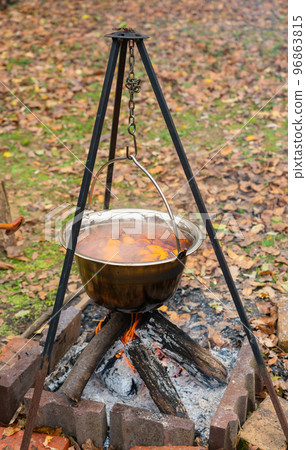 Autumn mulled wine from cinnamon oranges and wine is cooked on a fire 96863815