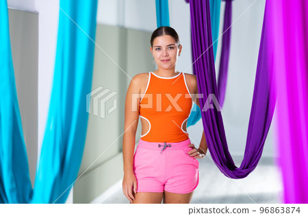 Young girls are warming up before doing aerial yoga Young girls are warming up before doing aerial yoga 96863874