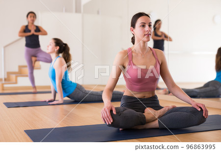 Young woman practicing yoga meditation in lotus positions Young woman practicing yoga meditation in lotus positions 96863995