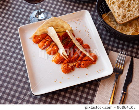 Spicy Muhammara dip from Aleppo pepper and walnuts with flatbread 96864105