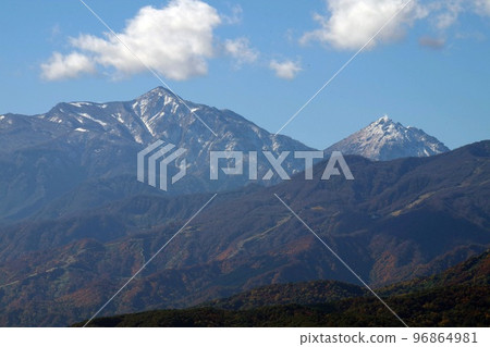 Kubiki Sanzan, Mt. Hiuchi and Mt. Niigata Yakeyama covered with snow in late autumn 96864981