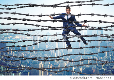 Businessman in barbed wire concept 96865633