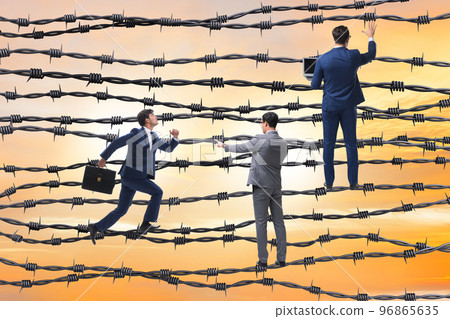 Businessman in barbed wire concept 96865635