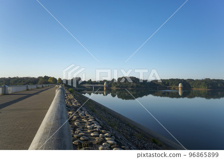 The lake surface and water intake tower of Lake Tama in the blue sky in autumn located on the Sayama Hills The lake surface and water intake tower of Lake Tama in the blue sky in autumn located on the Sayama Hills 96865899