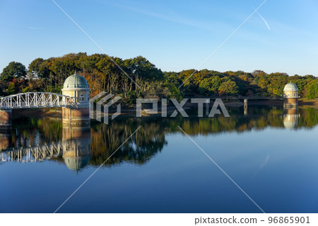 The lake surface and water intake tower of Lake Tama in the blue sky in autumn located on the Sayama Hills The lake surface and water intake tower of Lake Tama in the blue sky in autumn located on the Sayama Hills 96865901
