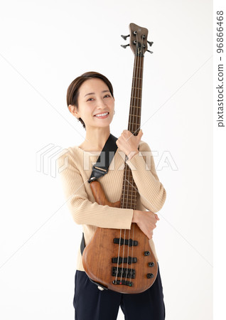 Woman playing bass White background 96866468