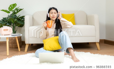 Home lifestyle woman relaxing lying down in living room. 96866593