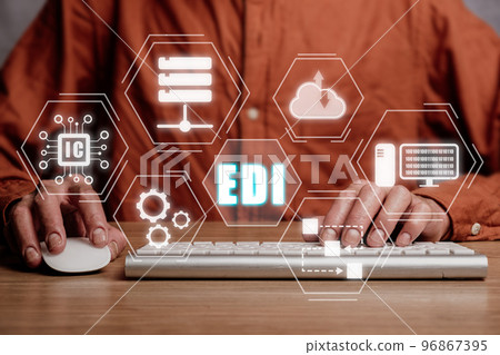 EDI-electronic data interchange concept, Person using computer on office desk with virtual screen EDI icon. 96867395