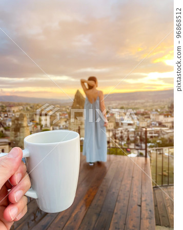 Young woman in dress on the roof with amazing view of Cappadocia in Turkey 96868512