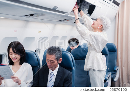 Passengers taking out carry-on luggage Passengers taking out carry-on luggage 96870100