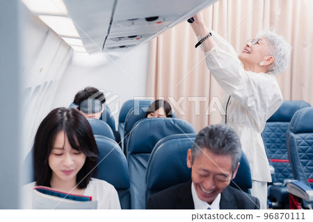 Passengers taking out carry-on luggage 96870111