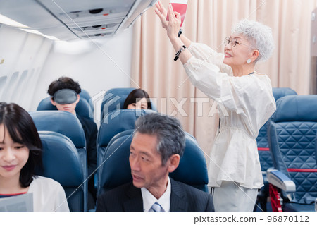 Passengers taking out carry-on luggage 96870112
