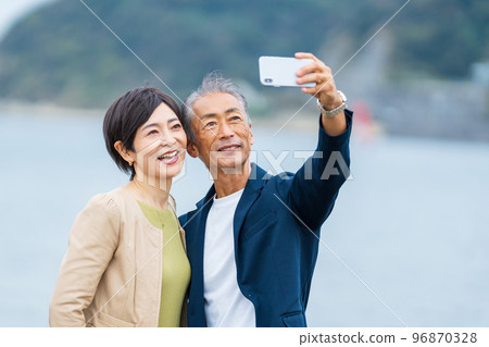 Senior couple taking a selfie with a smartphone Senior couple taking a selfie with a smartphone 96870328