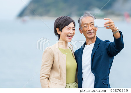 Senior couple taking a selfie with a smartphone Senior couple taking a selfie with a smartphone 96870329