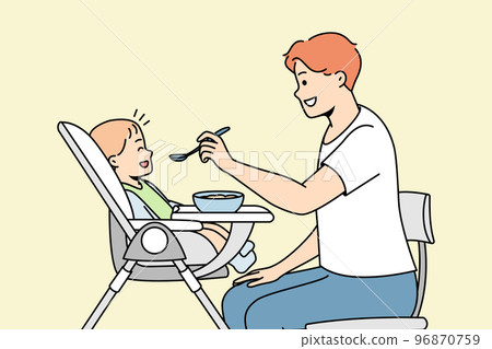 Young dad feeds baby sitting in highchair from spoon. 96870759