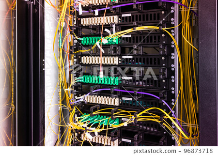 Fiber Optic cables connected to an optic ports - data switch in internet data center 96873718