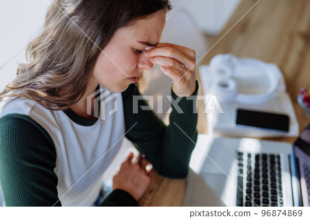Portrait of tired woman with laptop, homeoffice concept. 96874869